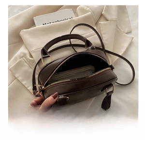 Top view of deep brown leather bag interior showing capacity for wallet and essentials