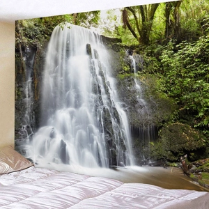 Detailed view of forest waterfall tapestry hanging as a wall decoration in a bedroom