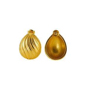 Macro view of gold teardrop earrings featuring an irregular rippled texture surface