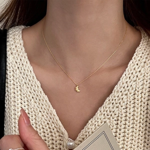 Elegant gold S925 silver croissant pendant necklace on model in French minimalist style