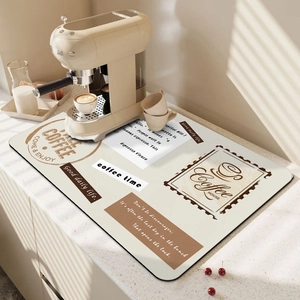 Absorbent coffee machine mat with TAKE COFFEE print on a modern kitchen countertop
