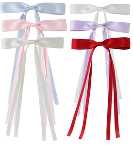 Detail showing various colors of satin bow hair clips with long streamers for women