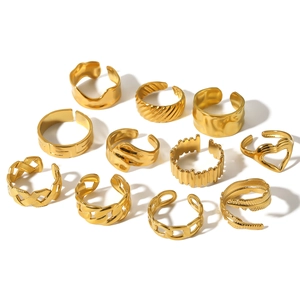 Set of 11 golden adjustable minimalist stainless steel rings for women on white background