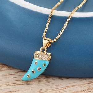 Macro detail of gold horn pendant with vibrant sky blue finish and colorful crystals