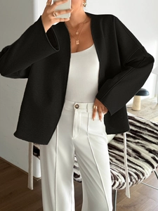 Detail of a casual black open-front tie cardigan blazer with a loose fashion fit