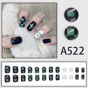 Press-on nail set with black and green heart checkerboard and star pattern designs