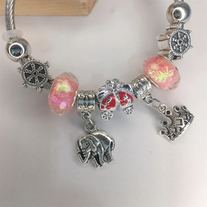 Silver charm bracelet with pink glass beads, elephant and crown charms on snake chain