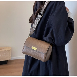 Brown litchi texture crossbody bag with geometric wide strap and golden buckle detail