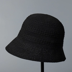 Detailed view of the breathable hollow knit texture on this black foldable bucket hat