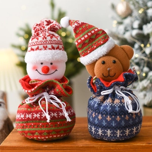 Christmas knit gift bags with snowman and bear designs featuring festive drawstring patterns