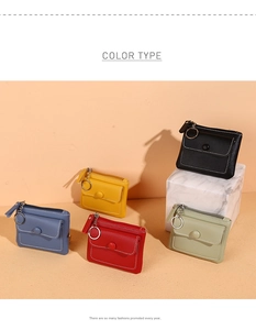 Detailed view of small PU leather wallets in black, red, yellow, blue and green on marble