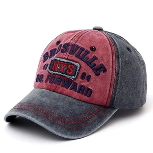 Detail of vintage washed cotton baseball cap with embroidered lettering and stitching