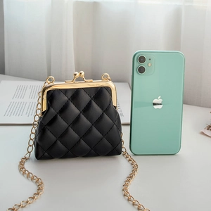 Mini black quilted wallet with metal clasp and gold chain next to a mobile phone