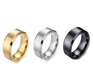 Detail view of brushed stainless steel rings in gold, silver, and black with matte finish