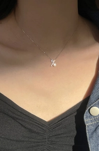 Detail of s925 silver necklace with percentage symbol pendant and freshwater pearl