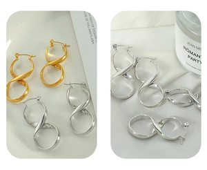 Detail view of twisted infinity hoop earrings in polished gold and silver finishes