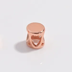 Detailed view of rose gold S925 silver cylinder bead with hollow heart design and dots