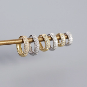 Three-row pavé cubic zirconia wide hoop earrings in gold and silver plating