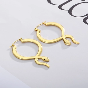 French style 18K gold plated stainless steel snake hoop earrings on a magazine background