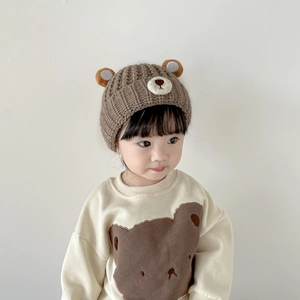 Detail of baby bear ear knit hat and matching cream sweatshirt with bear print