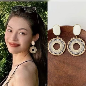 Elegant gold-framed woven hoop earrings with resin shell detail and natural holiday style