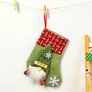 Detail of Christmas stocking with gnome motif hanging by a wooden clip on a twine rope