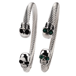 Skull stainless steel C-shaped twisted cable bracelet with green and black eyes