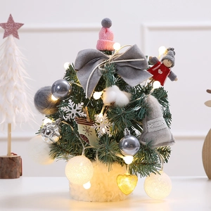 Mini table Christmas tree with warm LED lights, pink knit hat and decorative ornaments