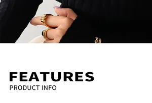 Detail of twisted gold ring and square gem ring worn with black knit clothing