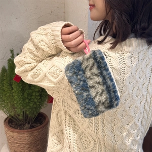 Close-up of soft plush striped pouch for coins and lipstick held by hand