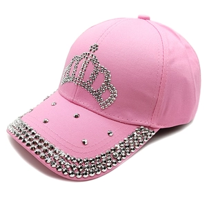 Detailed close-up of a pink baseball cap with crown rhinestones and metallic stud accents