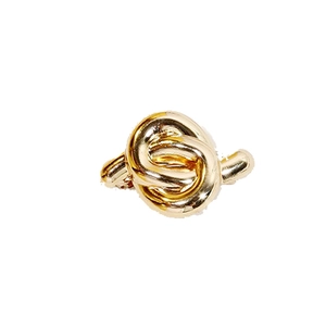 Minimalist gold metal spring hair clip featuring a twisted knot design on white background
