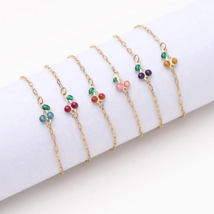 Set of six gold plated stainless steel cherry charm bracelets in assorted vibrant colors