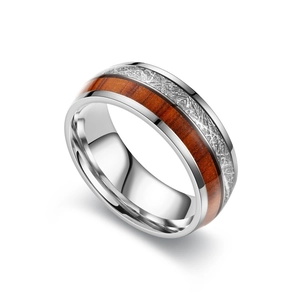 Close-up detail of a vintage titanium steel ring with wood and meteorite pattern inlay