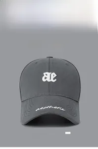 Detail of grey cotton baseball cap with white 3D ae embroidery and aesthetic script on brim