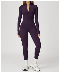 Detail view of deep purple thermal yoga jumpsuit with front zipper and stand-up collar