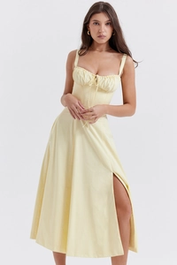 Detail of light yellow summer maxi dress with ruched drawstring chest and high slit