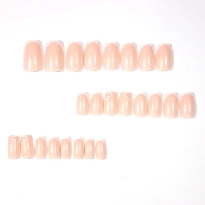 Glossy nude pink press-on nails set with white French tips and heart patterns