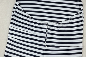 Detail of invisible zipper closure and striped pattern on the cowled neckline