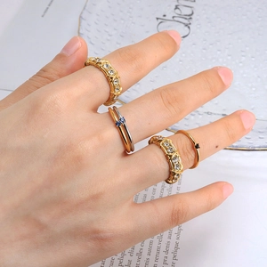 Elegant gold and silver crisscross rings with blue and black gemstones for women