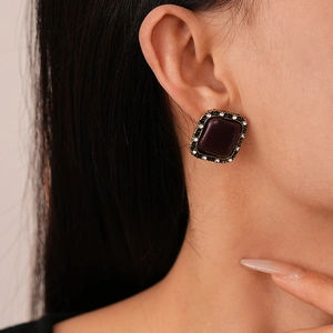 Detail view of vintage square fabric earring with rhinestones and bronze frame