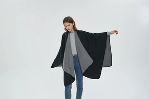 Detail showing high-quality drape and stitching on double-sided black and grey shawl
