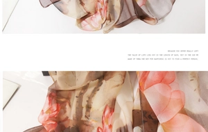 Detail of thin silk scarf showing pink lotus print on coffee beige chiffon fabric