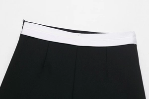 Detail of high-waist patchwork design and stitching on black and white skort set