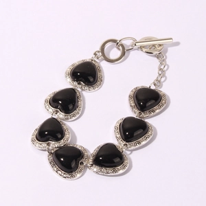 Vintage heart bracelet with black stones and engraved silver frames featuring a toggle clasp