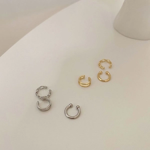 Close-up of minimalist six-piece ear cuff set in gold and silver finishes