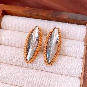 Elegant gold marquise teardrop stud earrings with sparkling faceted crystal insets