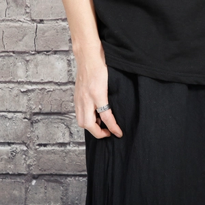 Detailed view of silver titanium steel ring with vintage hammered texture on male hand
