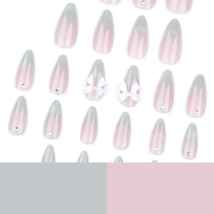 Sweet pink cat eye press-on nails with 3D white bows and sparkling crystal accents