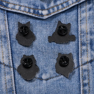 Cute cartoon cat alloy badges with butterfly clutch on blue denim fabric background